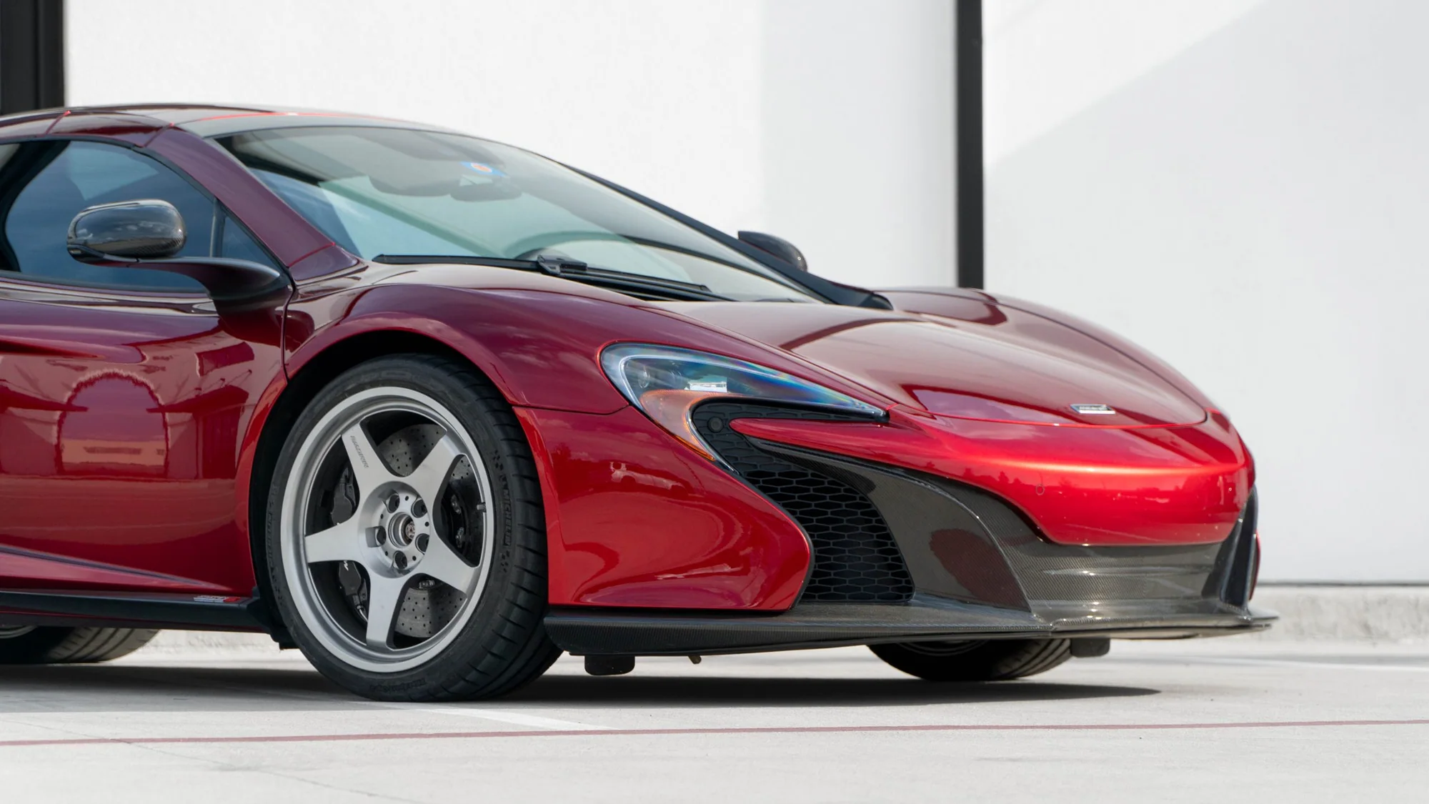 Red McLaren 650S front three-quarter on MMCW2 wheels