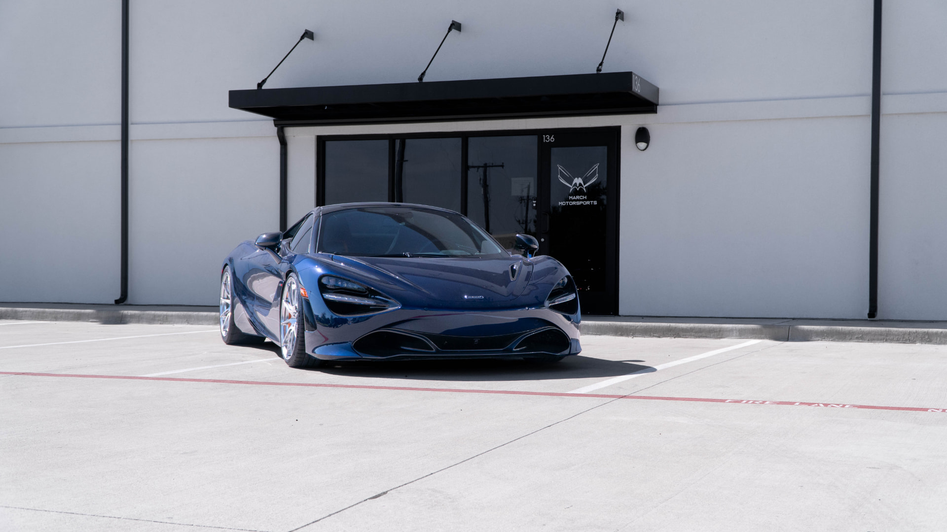 Blue McLaren 720S outside March Motorsports in Carrollton