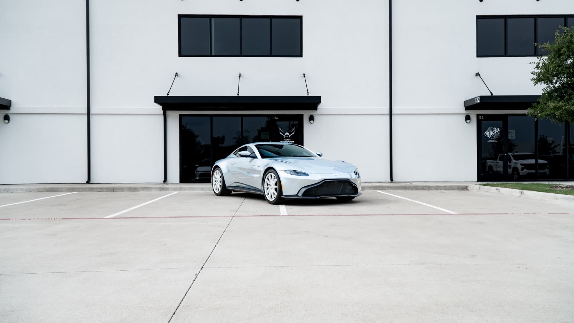 Silver Aston Martin Vantage outside March Motorsports in Carrollton, Texas