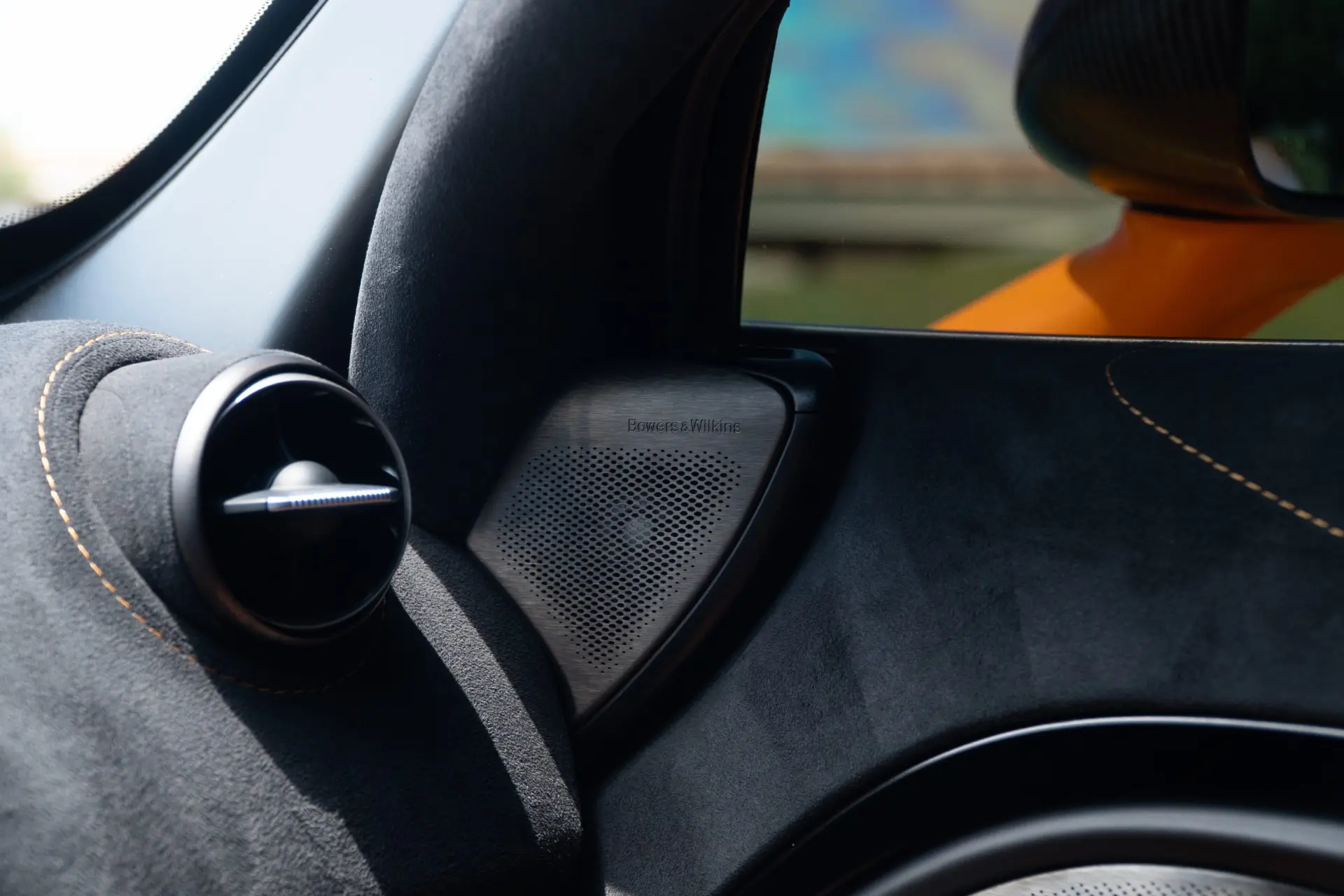 Factory dash tweeter in a McLaren — the stock speaker the upgrade replaces