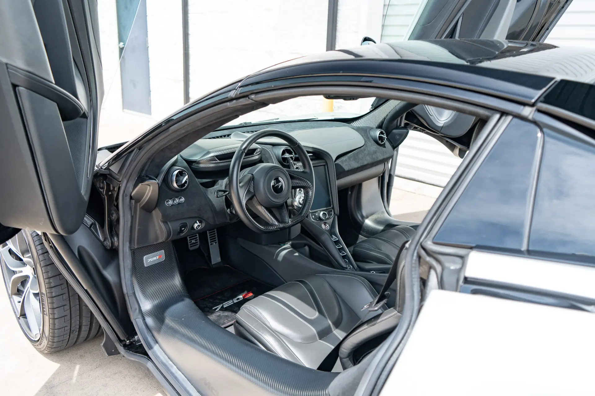 A 720S cabin with the butterfly doors open at March Motorsports
