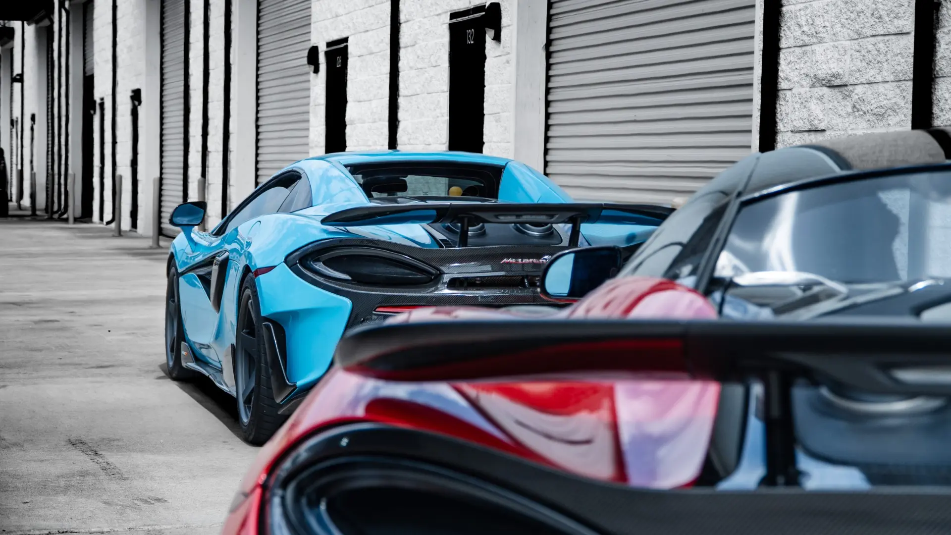 Blue McLaren 600LT Spider rear three-quarter showing its stance and ride height