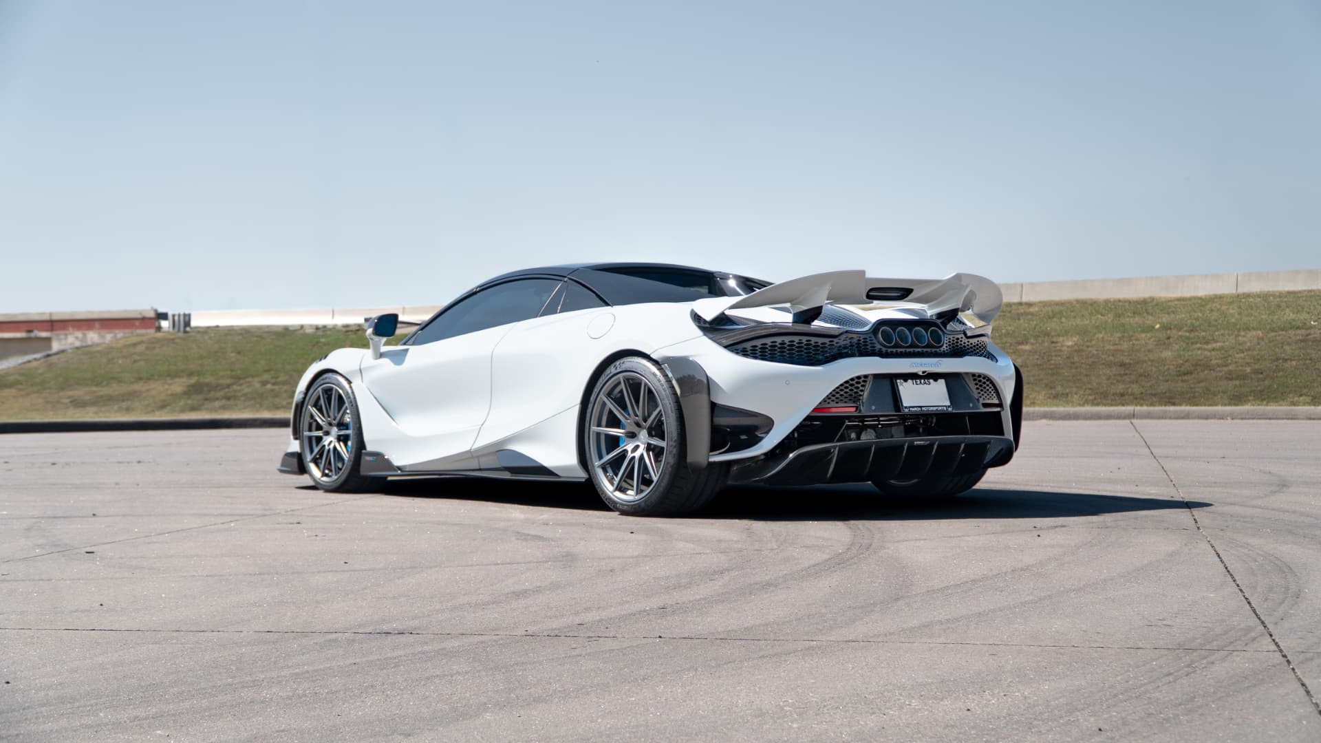 White McLaren 765LT rear three-quarter view outdoors