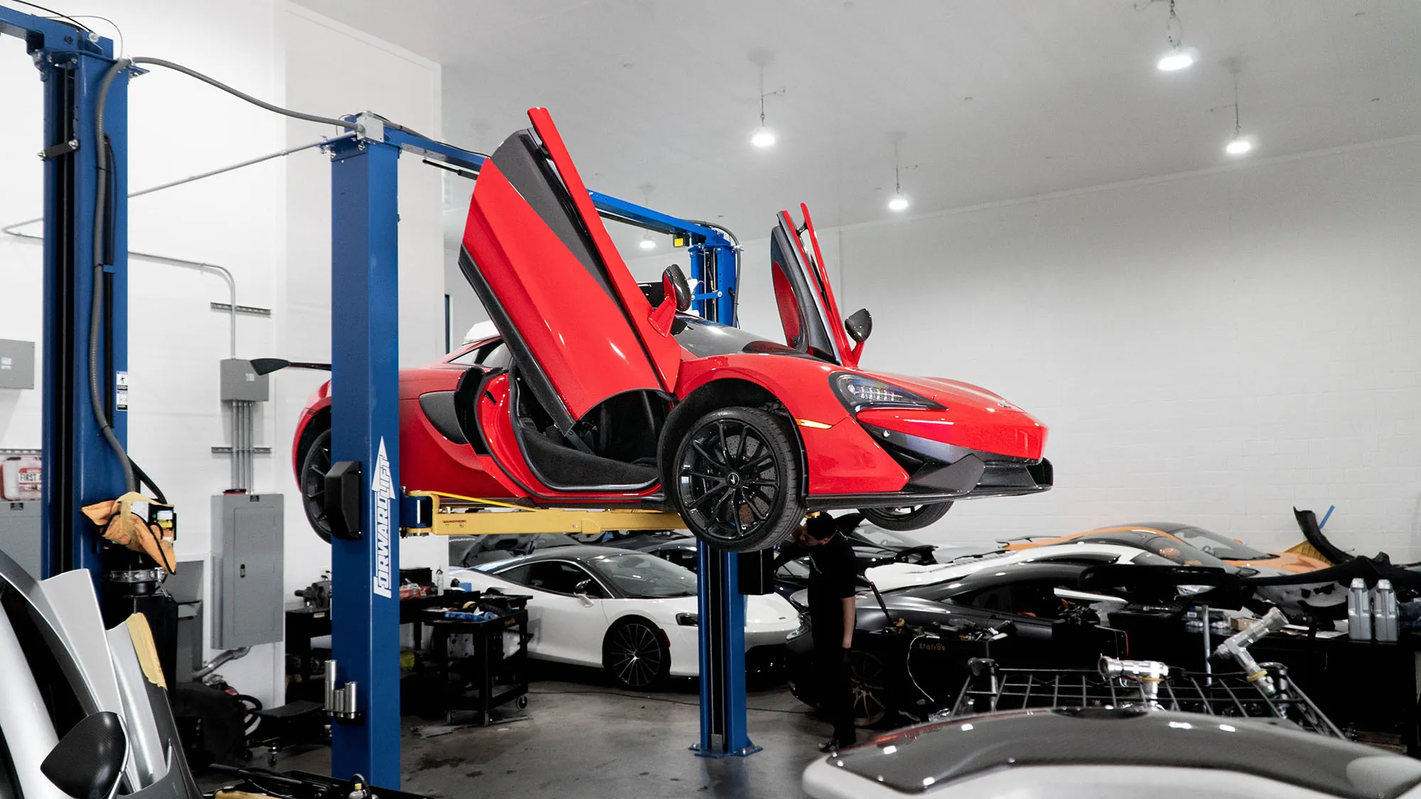 Red McLaren 570S on the lift at March Motorsports