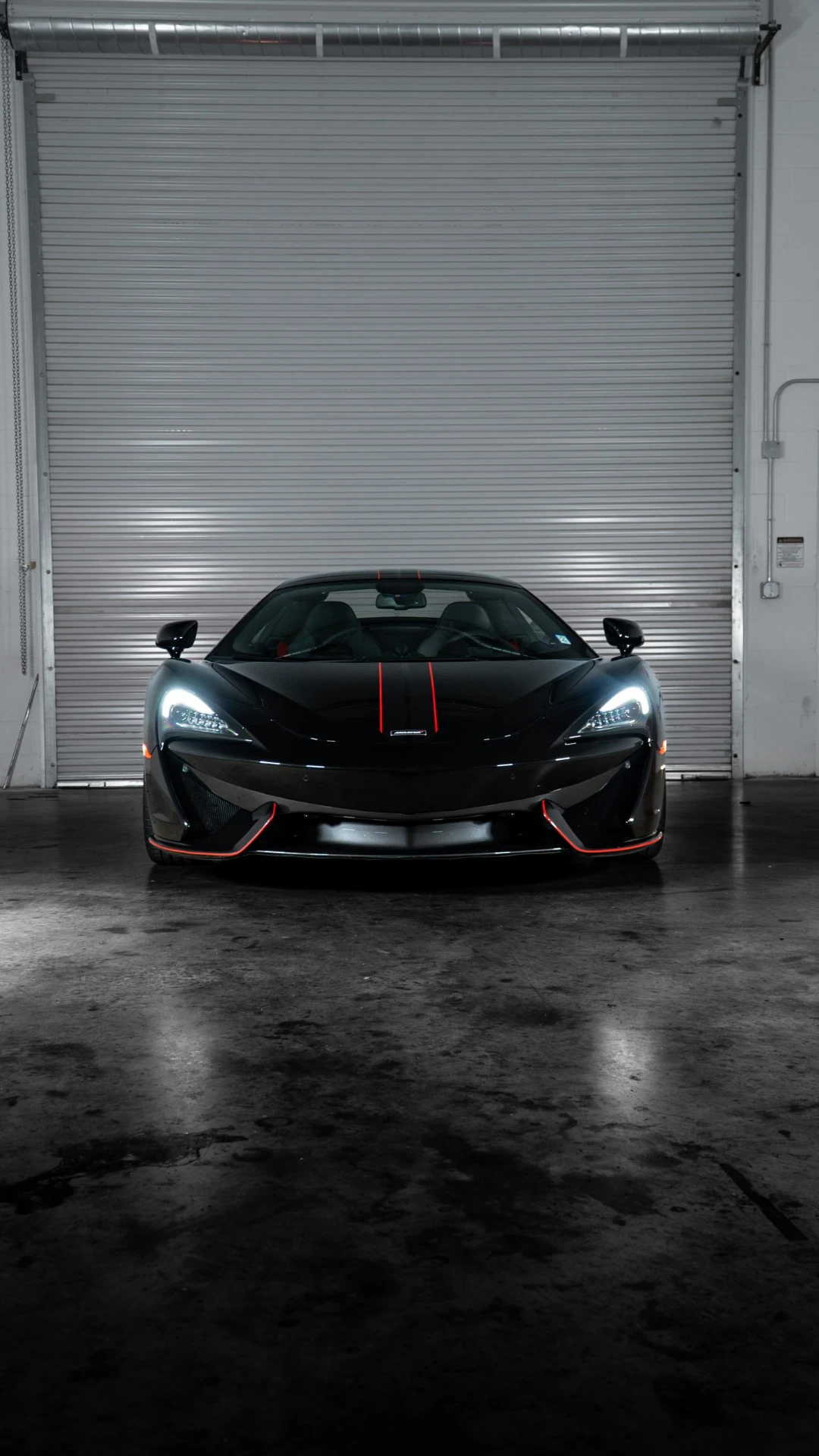 McLaren 570S head on with red accents in the March Motorsports workshop