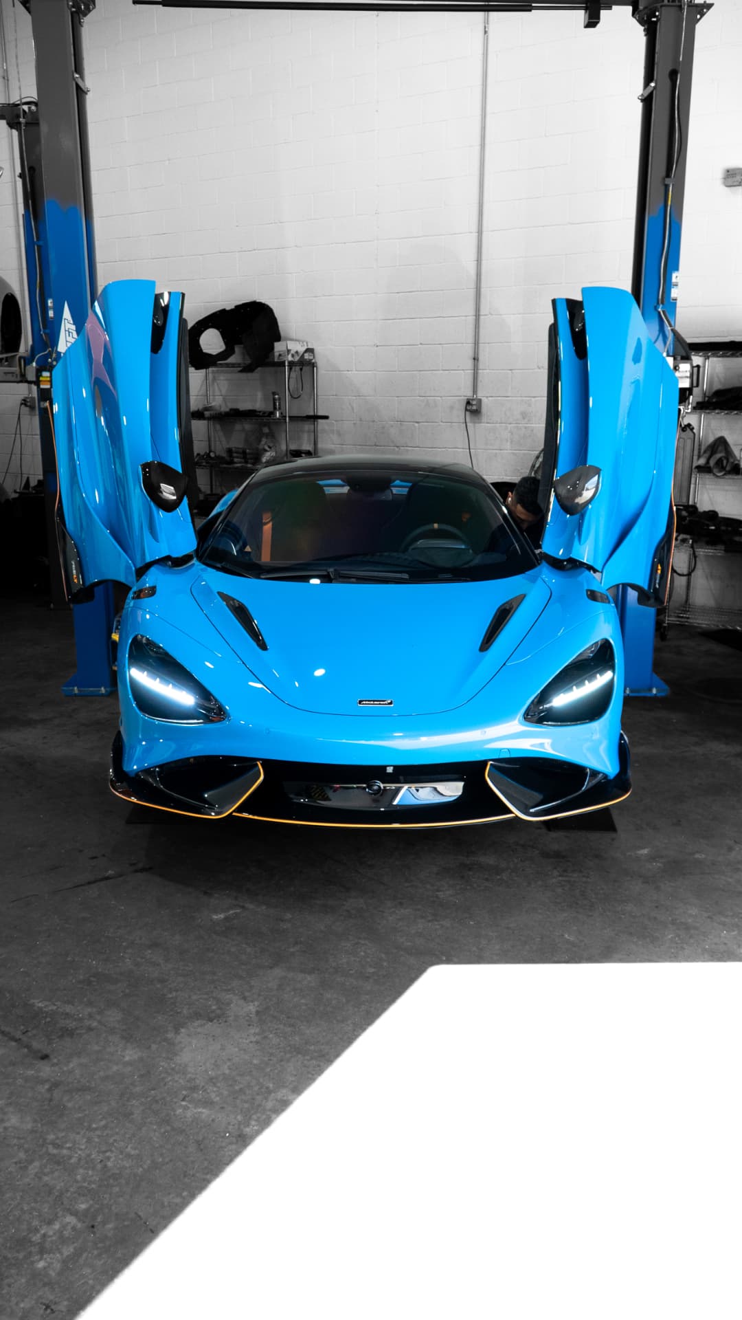 Blue McLaren 765LT with its dihedral doors open in the March Motorsports workshop