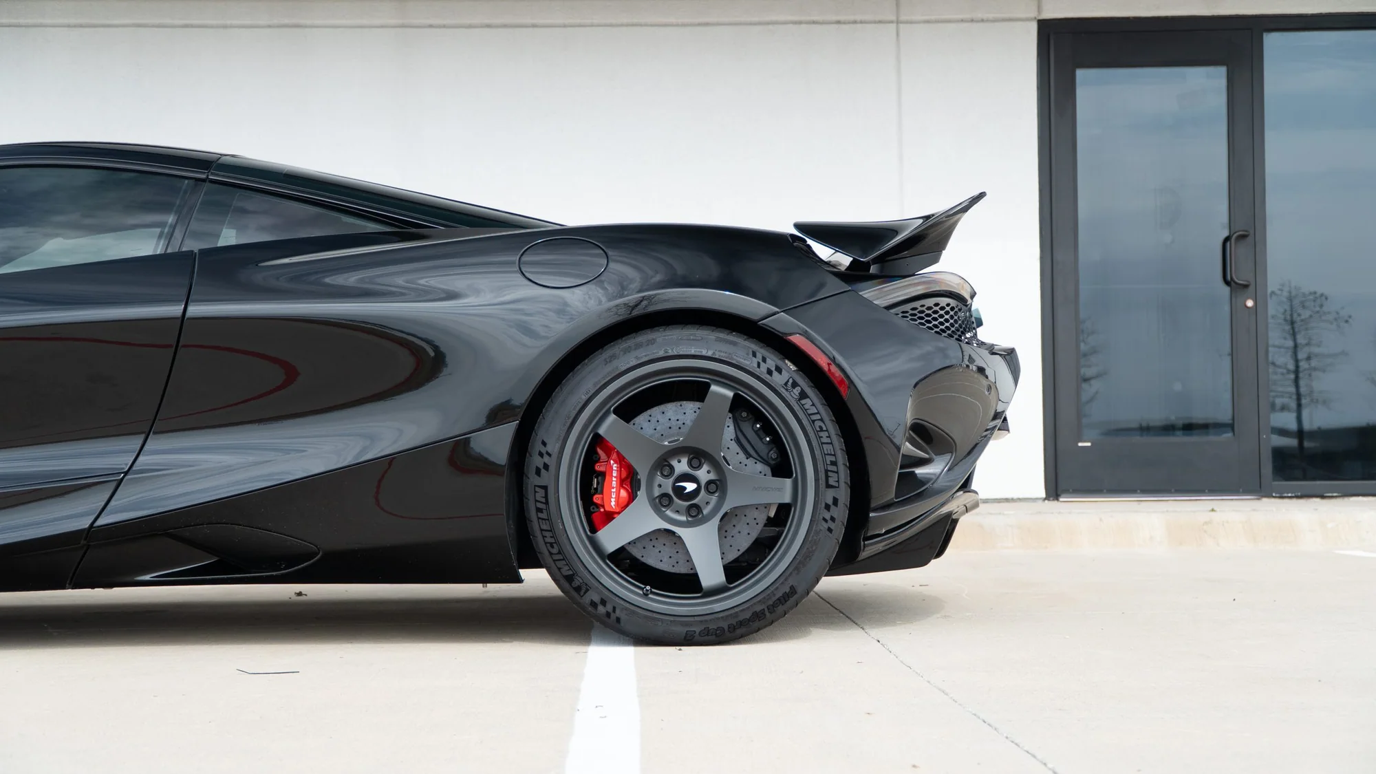 Black McLaren 750S rear three-quarter on MMCW2 wheels