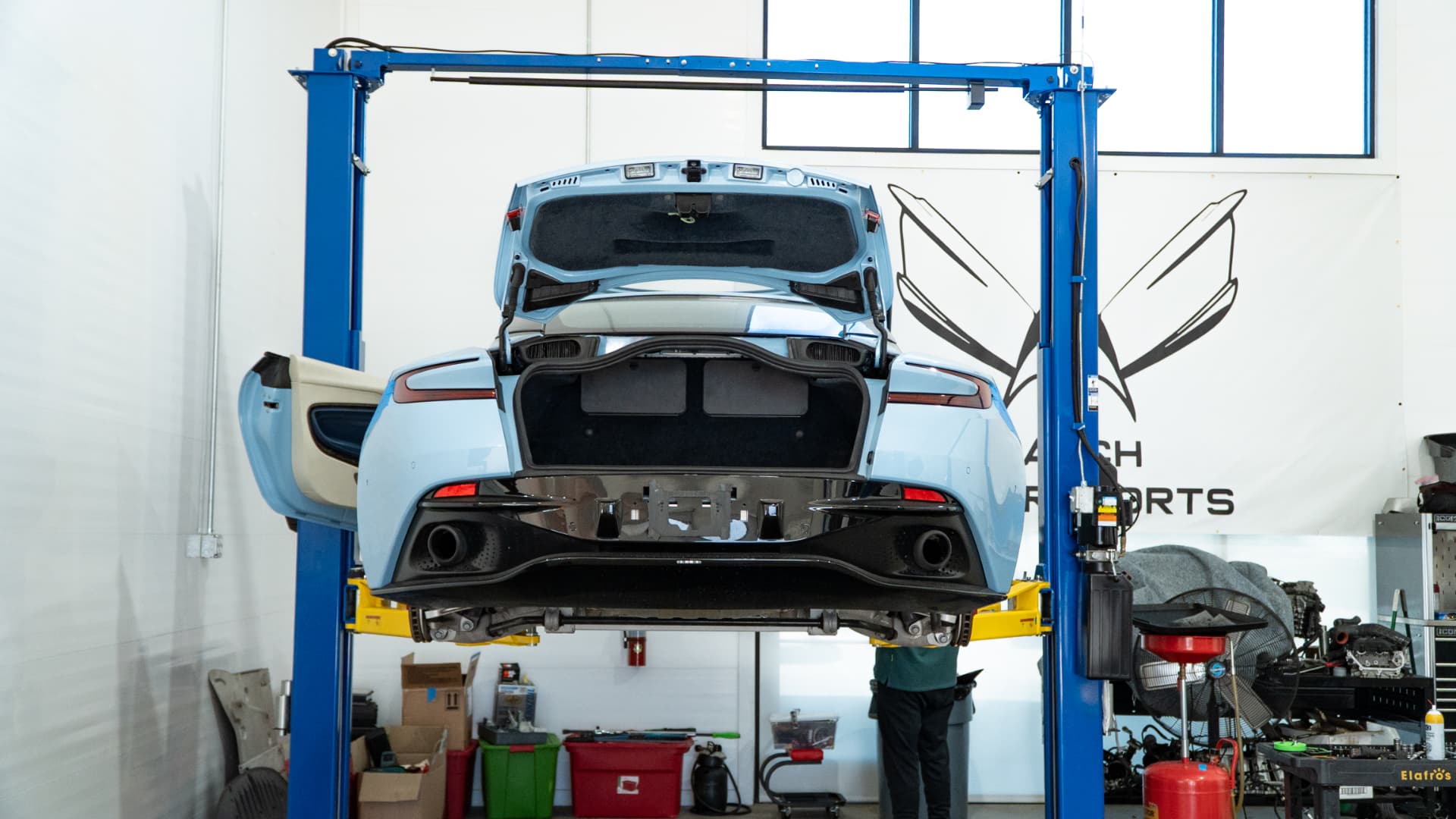 Light blue Aston Martin DB11 on the lift at March Motorsports in Carrollton