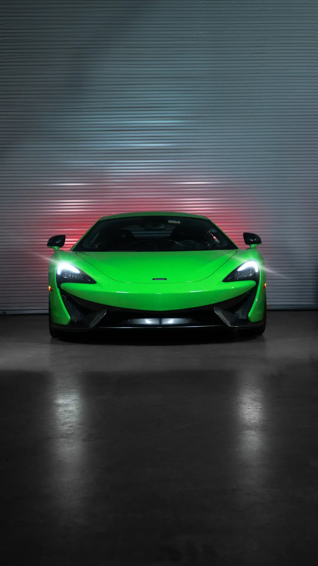 Green McLaren 570S outside the workshop