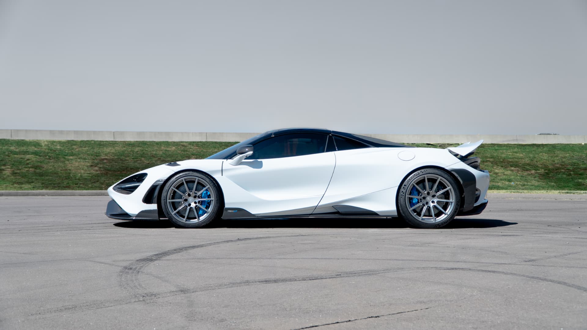 White McLaren 765LT side profile on a clear day