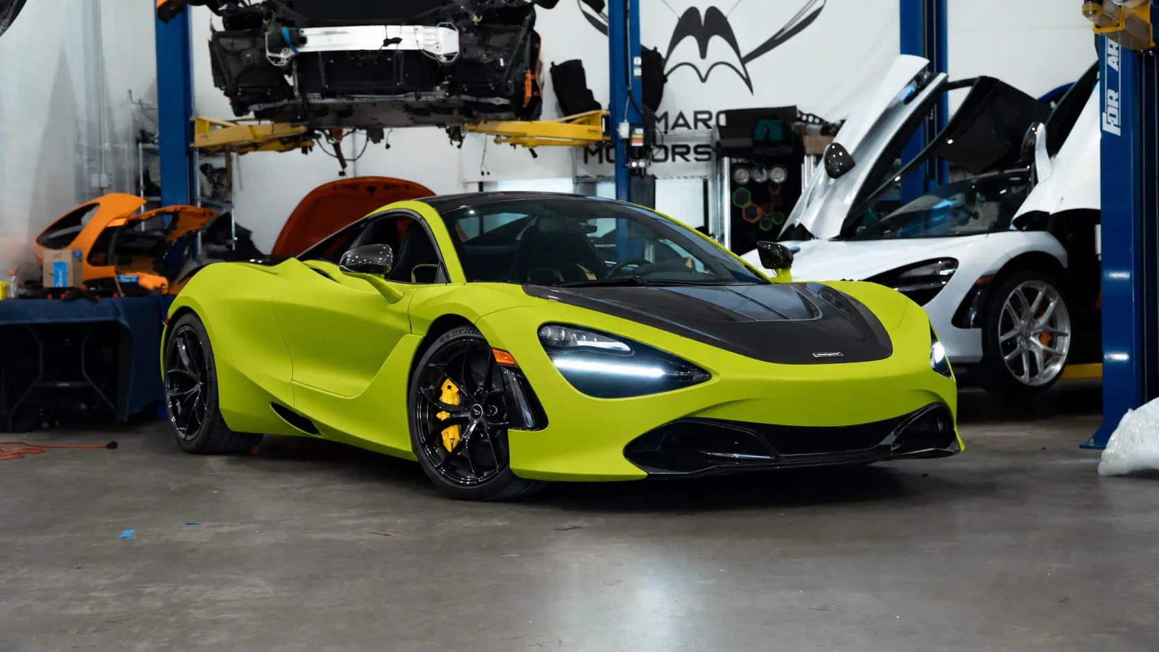 McLaren 720S in its original lime green finish on the March Motorsports shop floor before wrapping
