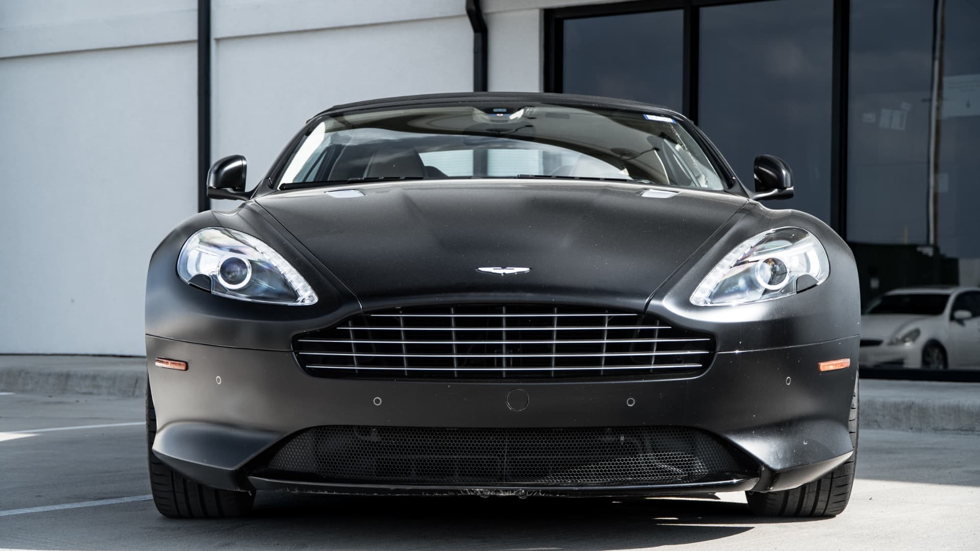 Aston Martin DB9 shown head-on outside March Motorsports in Carrollton