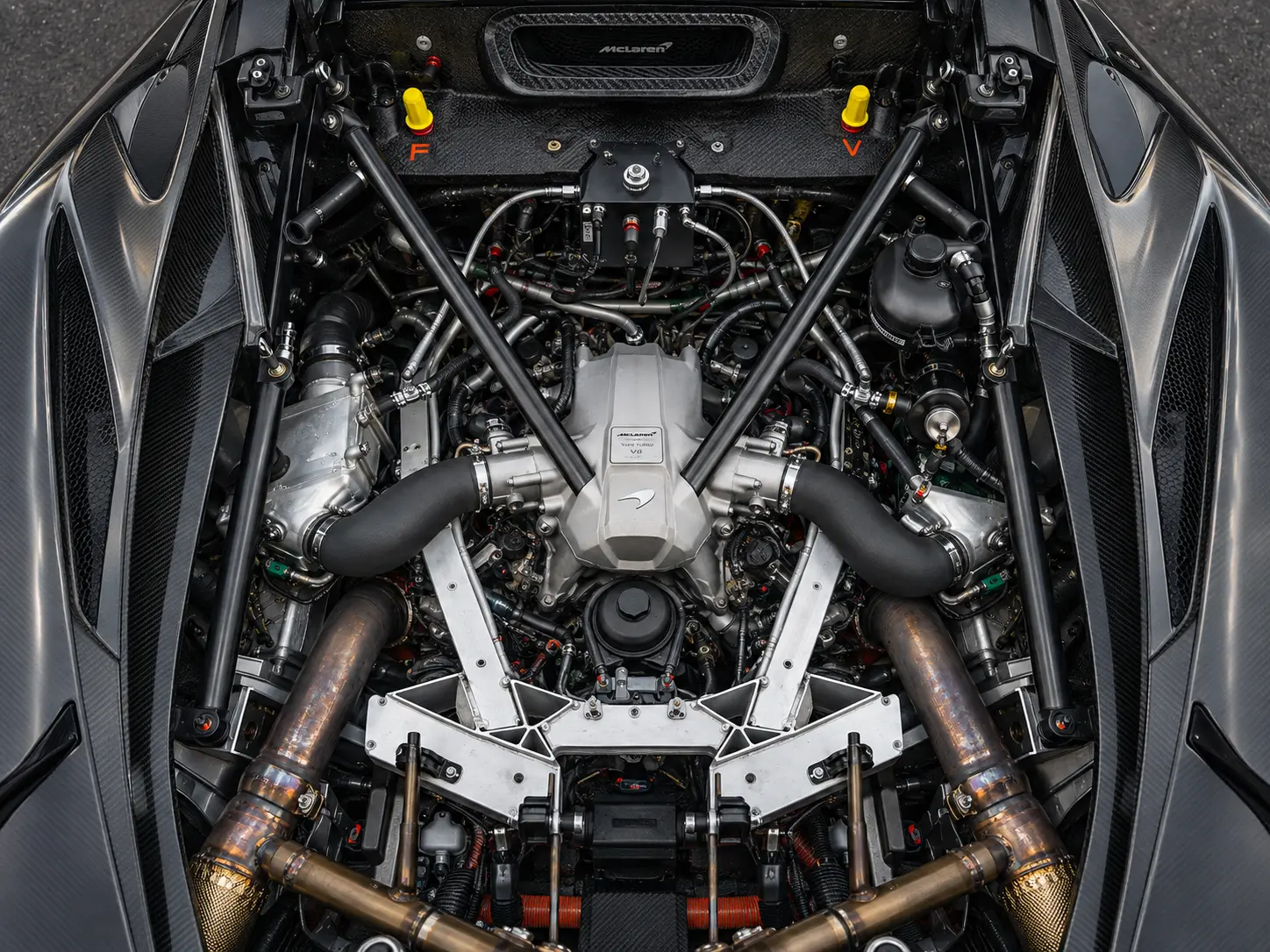 McLaren twin-turbo V8 engine bay with cooling and charge pipework