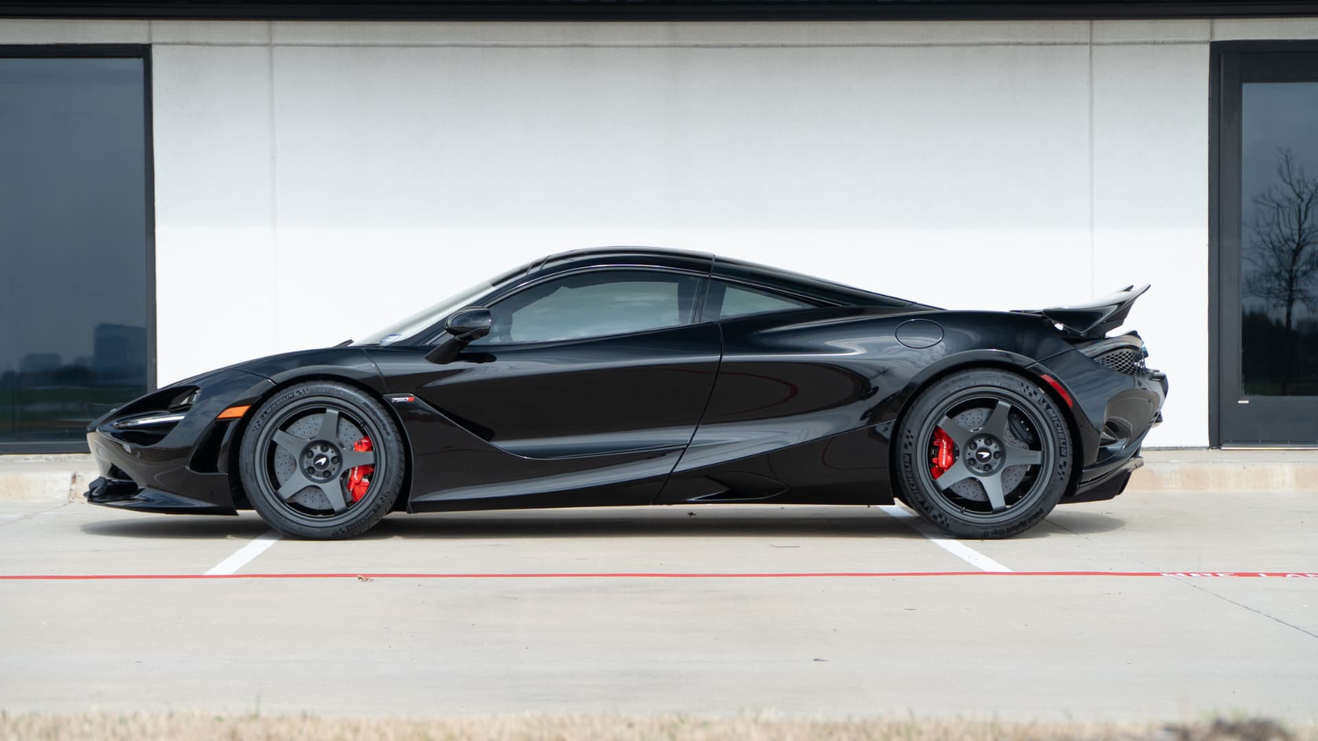 Black McLaren 750S side profile outside March Motorsports