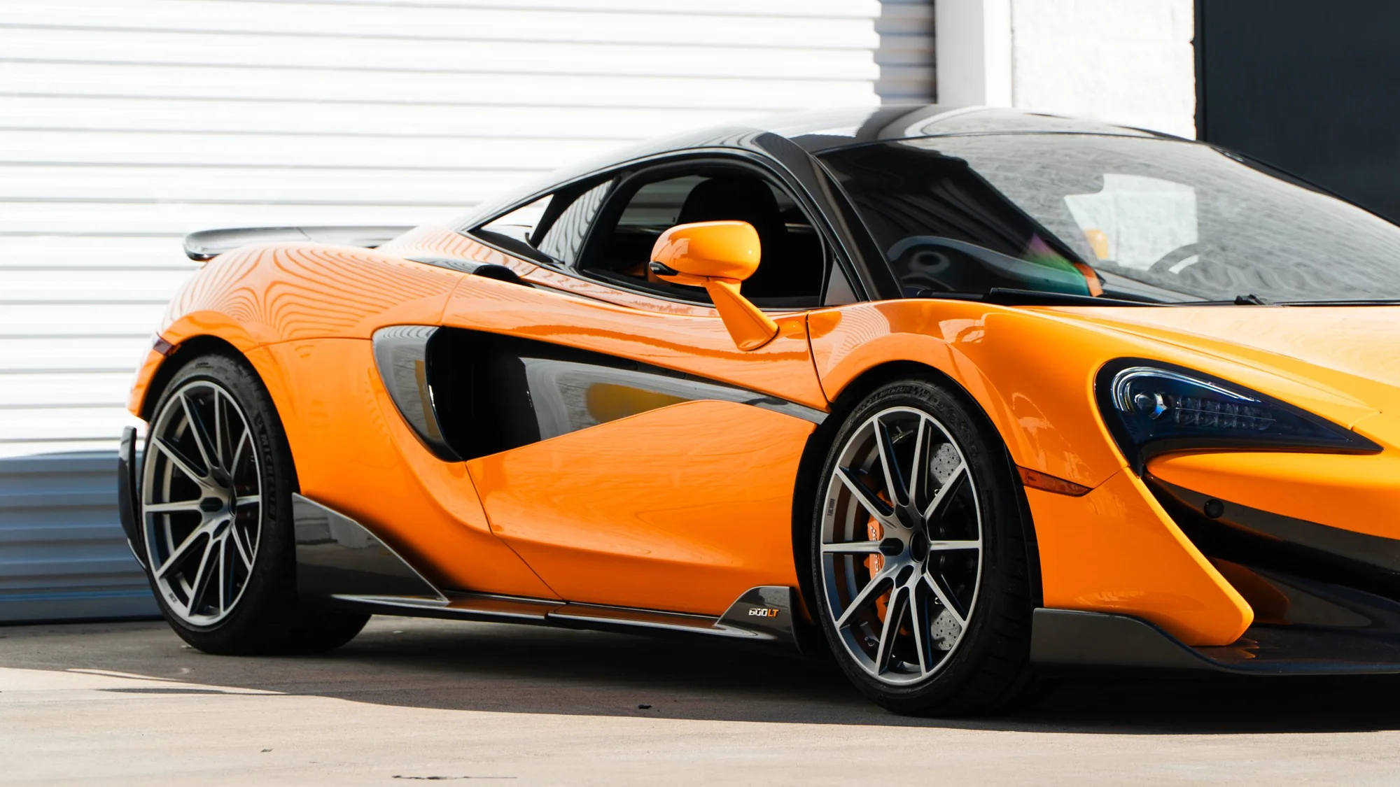Orange McLaren 600LT front three-quarter on MMCW1 wheels