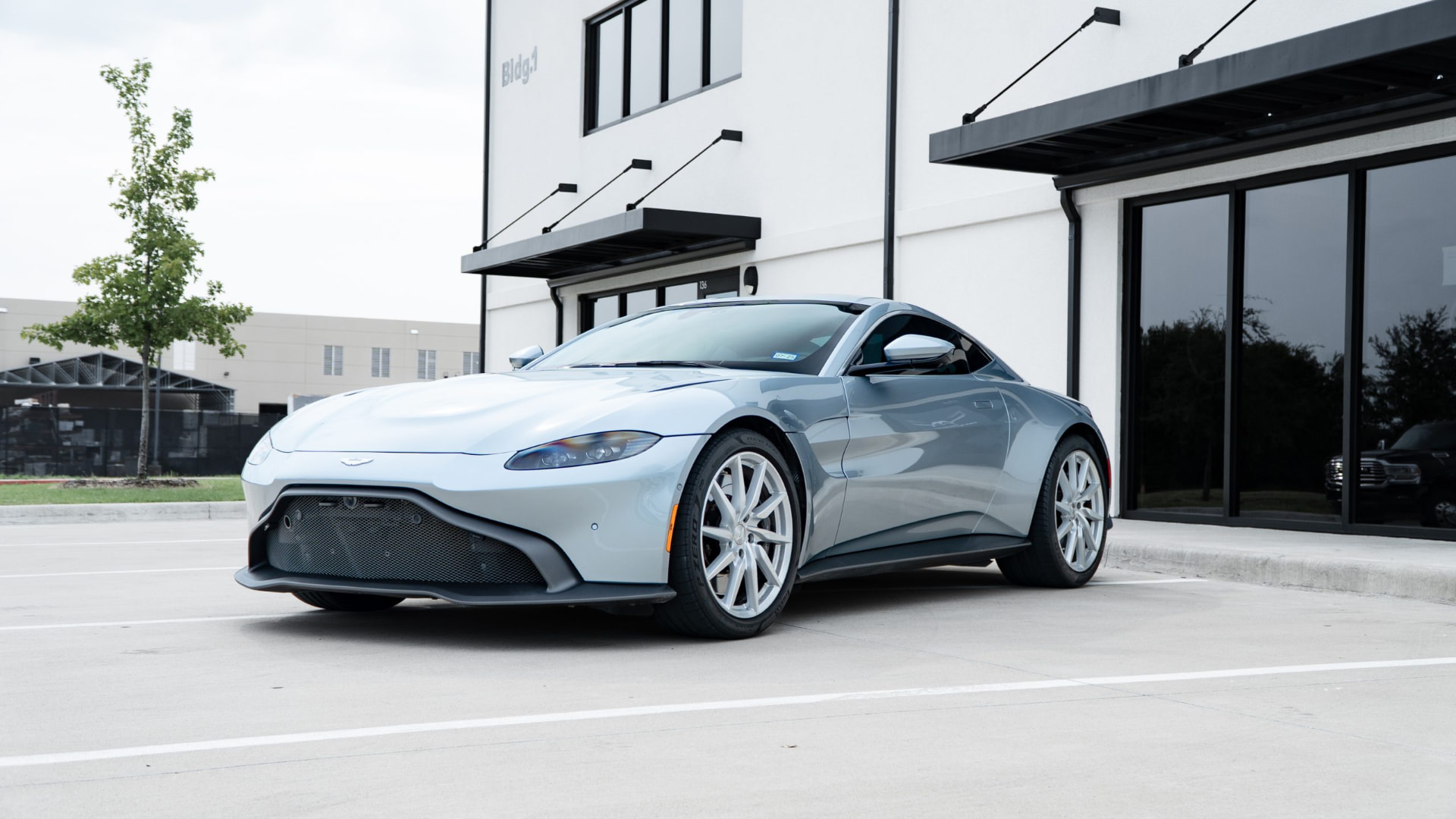 A silver Aston Martin Vantage parked outside March Motorsports
