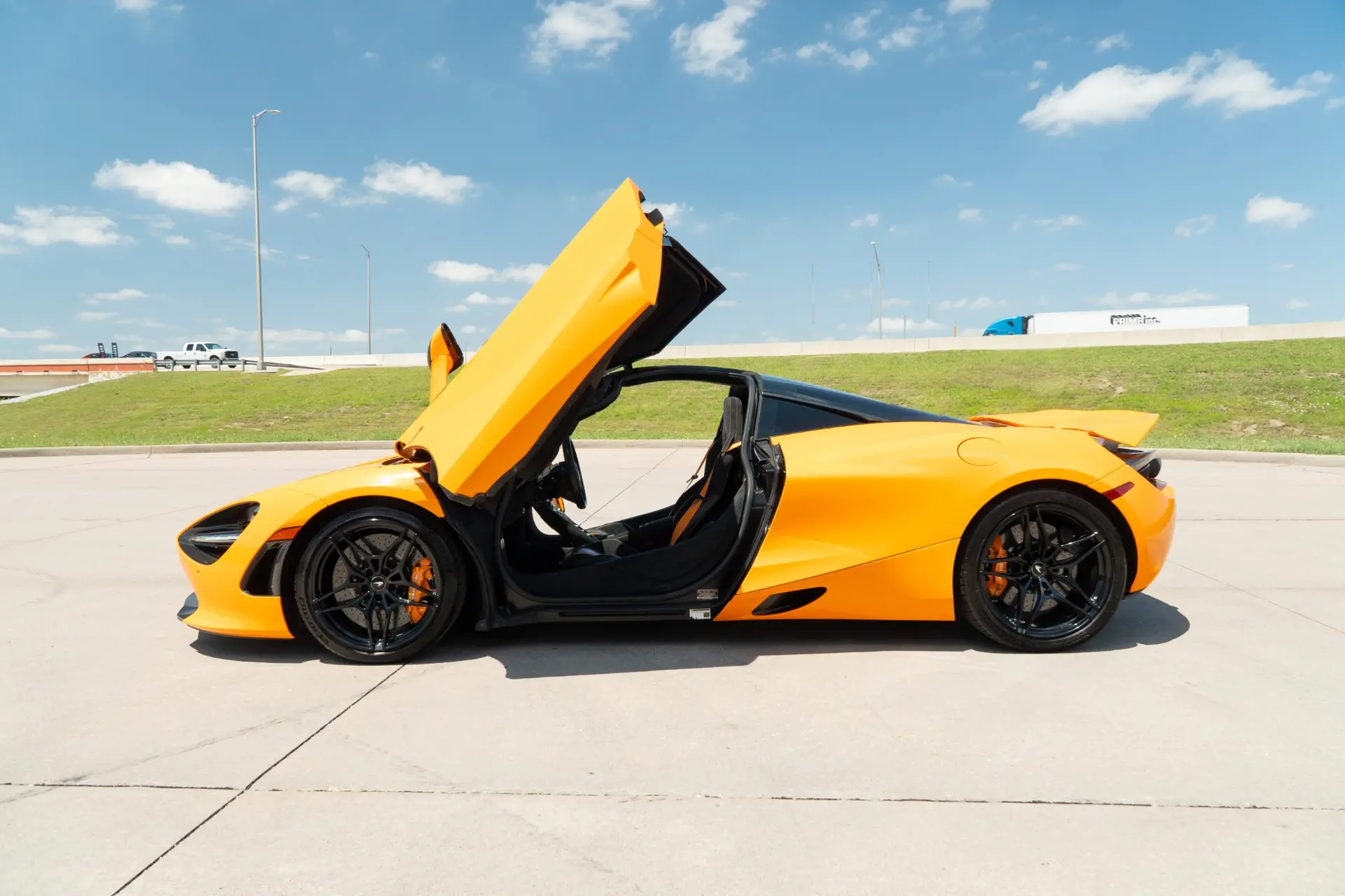 Papaya McLaren 720S with its dihedral door open, photographed for March Motorsports