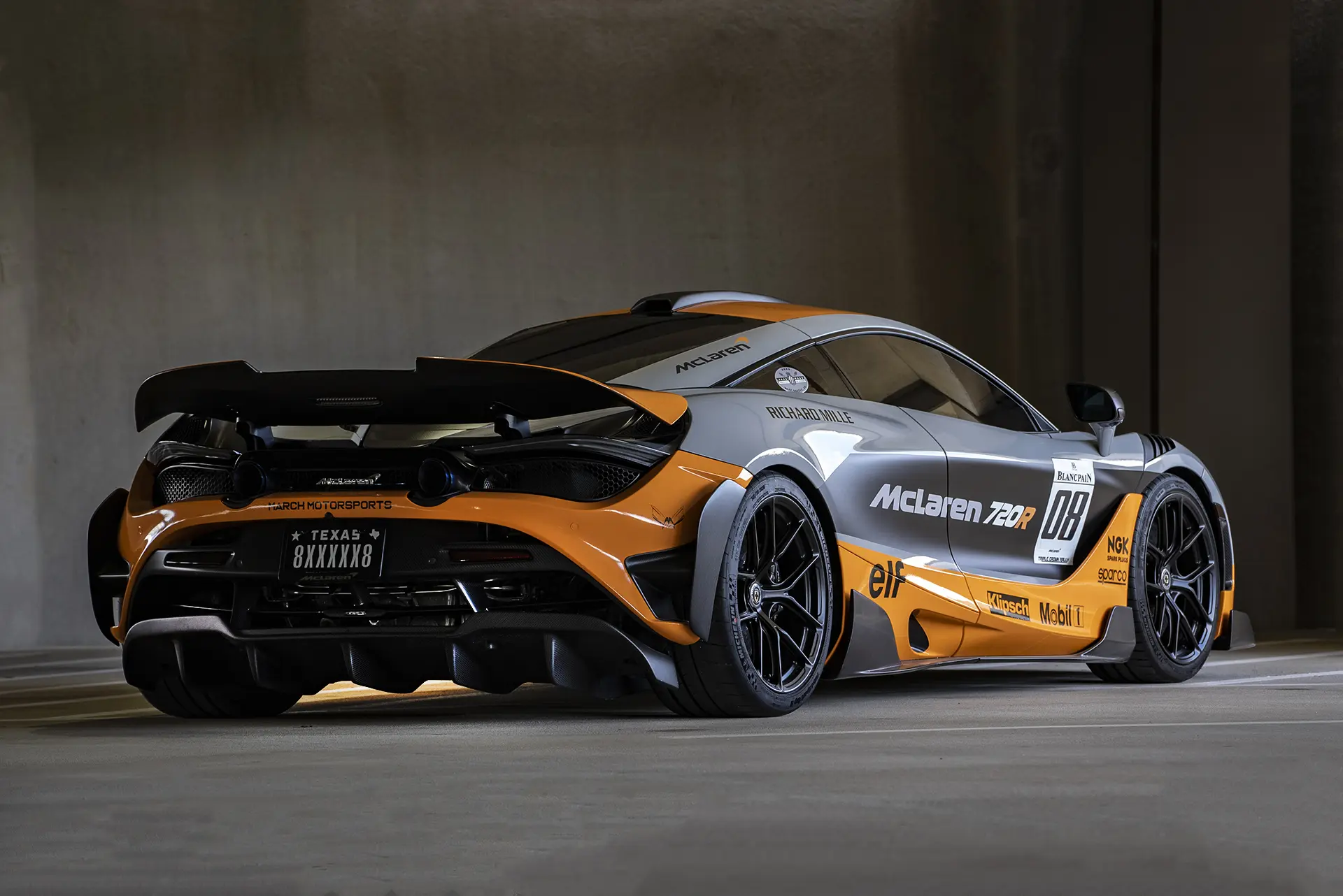 McLaren 720R in race livery with Texas plate parked in the garage at March Motorsports