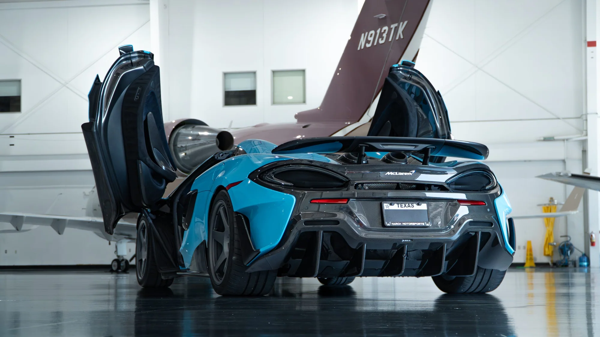 Blue McLaren with doors open on MMCW2 wheels