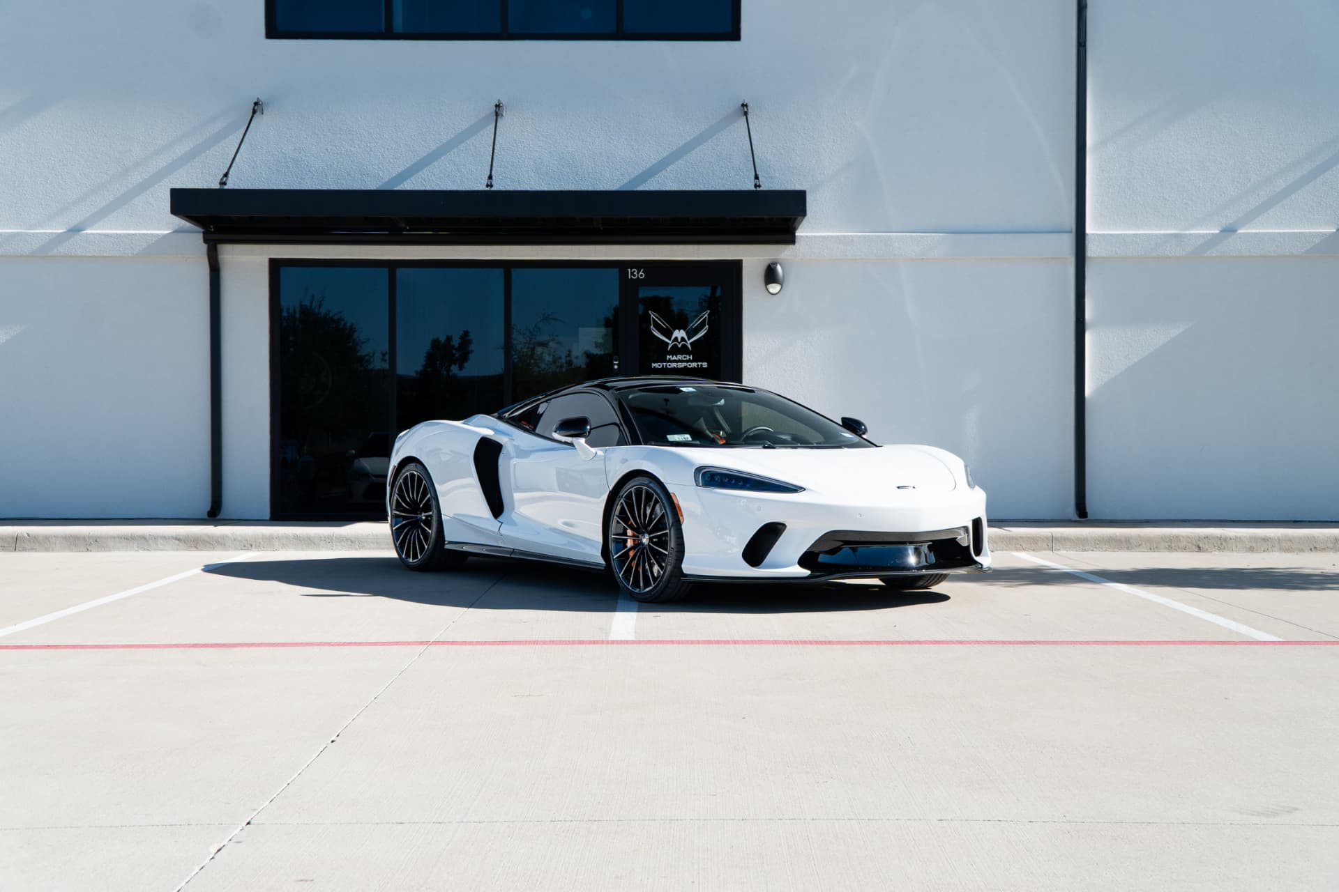White McLaren GT outside the March Motorsports entrance