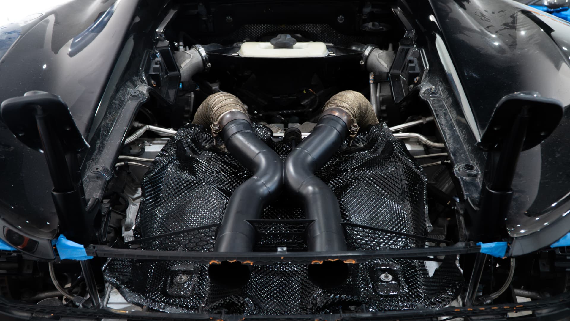 McLaren MP4-12C engine bay with heat-wrapped exhaust downpipes at March Motorsports