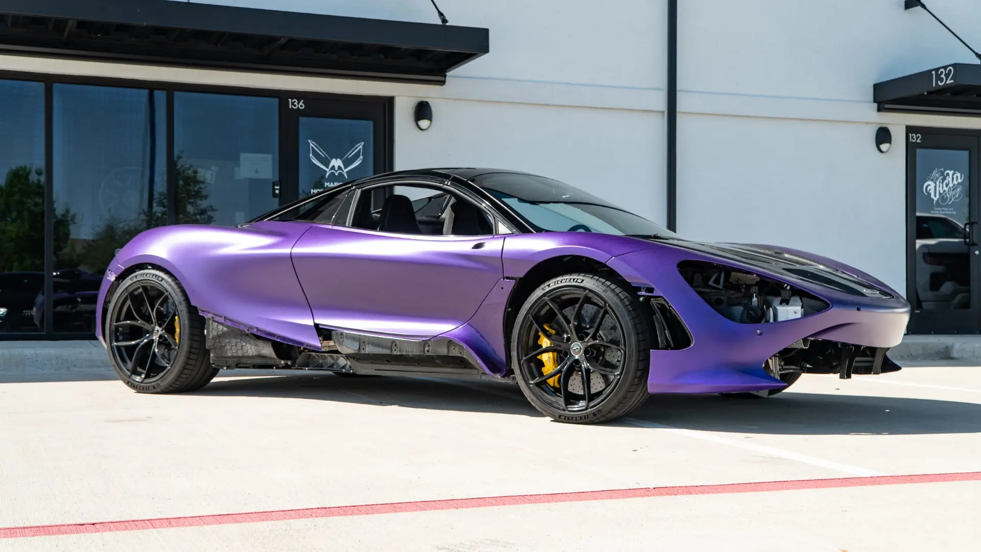 Satin purple wrapped McLaren 720S Spider outside the March Motorsports shop