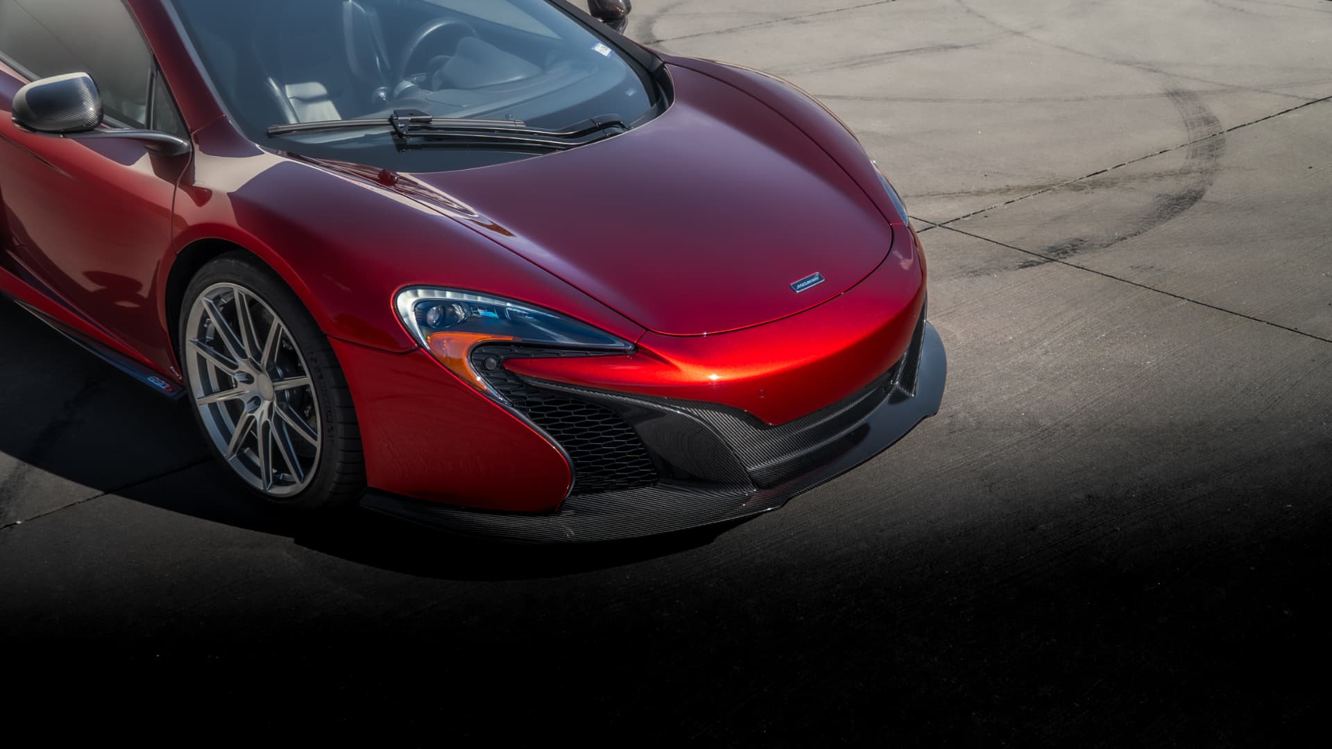 Volcano Red McLaren 650S Spider with carbon front splitter outside March Motorsports