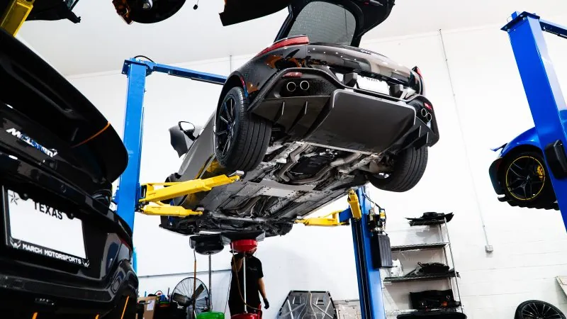 An Aston Martin raised on the shop lift